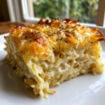 A delicious slice of Cheesy Hashbrown Breakfast Casserole with a golden-brown cheesy topping.