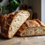 Close-up of a sliced Dutch Oven No Knead Crusty Bread, showing its airy crumb and golden crust.