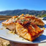 Close-up of two perfectly cooked fillets of Garlic Butter Salmon in 20 Minutes, glistening with sauce and herbs.