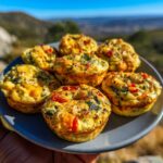 A plate of delicious High Protein Breakfast Muffins Meal Prep, featuring colorful vegetables and a golden-brown crust.