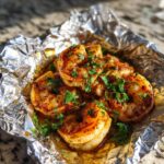Close-up of delicious Oven Baked Cajun Shrimp Foil Packets seasoned with spices and fresh parsley.