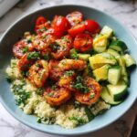 A vibrant Quick Healthy Shrimp and Quinoa Bowl with seasoned shrimp, cherry tomatoes, cucumber, and avocado.