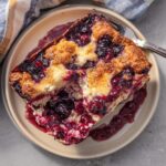 A delicious slice of Easy Blueberry Cottage Cheese Breakfast Bake, bursting with blueberries and a golden crust.