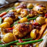 Close-up of sheet pan honey mustard chicken with roasted potatoes, carrots, and green beans.