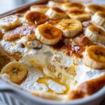 Close-up of a creamy Banana Pudding Cobbler Easy Summer Dessert topped with caramelized banana slices and a drizzle of sauce.