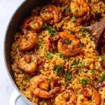 Close-up of a Cajun Shrimp and Rice Skillet, featuring plump, seasoned shrimp nestled in flavorful rice, garnished with fresh parsley.