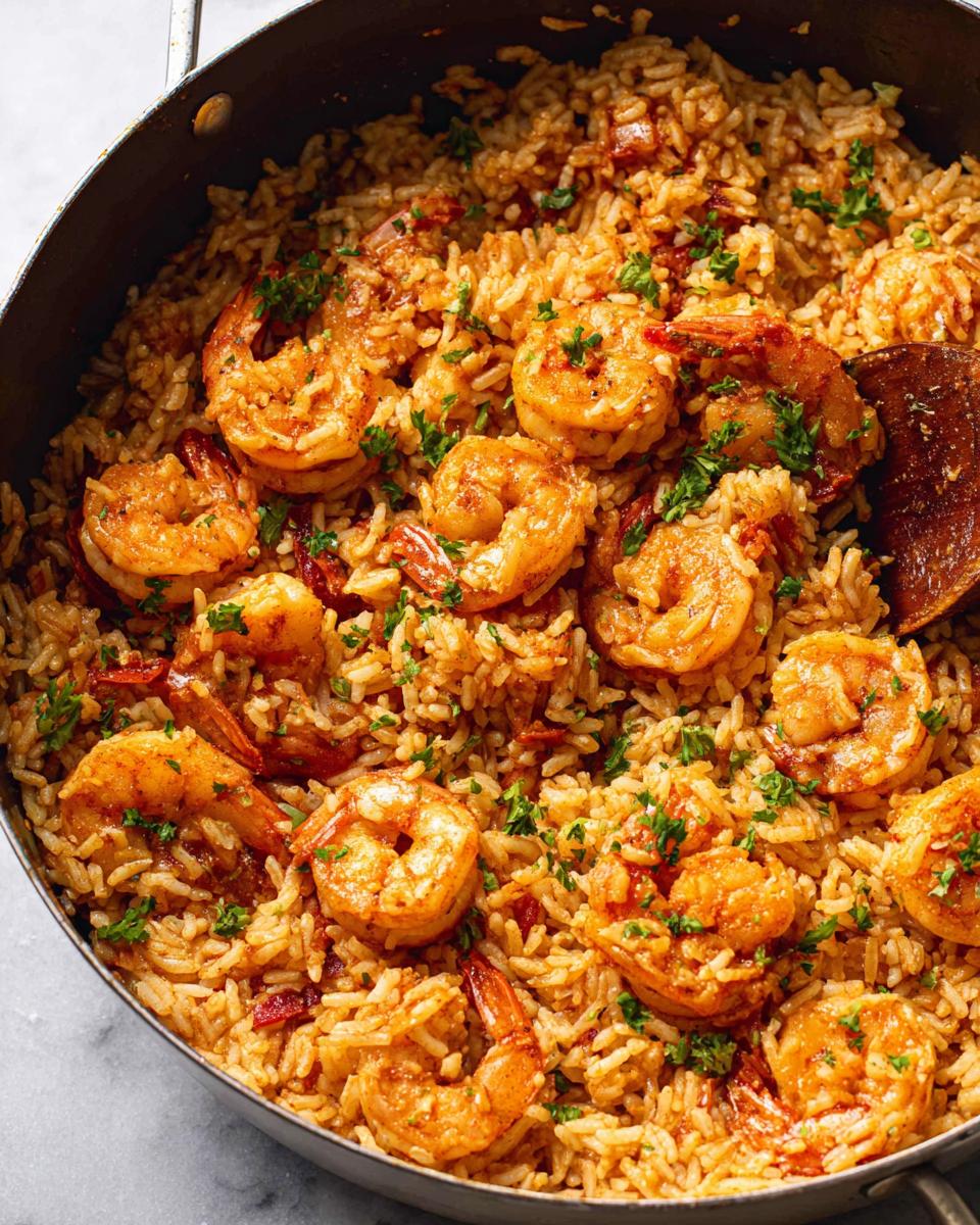 Close-up of a Cajun Shrimp and Rice Skillet, featuring plump shrimp nestled in flavorful rice, garnished with fresh parsley.