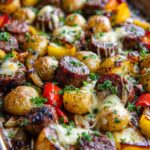 Close-up of a Cheesy Sausage and Potato One Pan Dinner with melted cheese and fresh parsley.