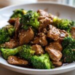 Close-up of Chicken Broccoli Stir Fry with Garlic Sauce, garnished with sesame seeds.