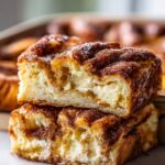 Close-up of two Churro Cream Cheese Danish Bars stacked, showing flaky pastry and creamy filling.