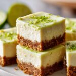 Stack of easy Key Lime Cheesecake Bars topped with fresh lime zest.