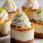 Close-up of no-bake Key Lime Cheesecake Cups topped with whipped cream and lime zest.