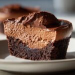 A close-up of a Rich Chocolate Mousse Brownie, showing the dense brownie base and airy chocolate mousse topping.
