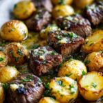 Close-up of Sheet Pan Garlic Butter Steak and Potatoes, showing juicy steak bites and golden roasted potatoes with herbs.